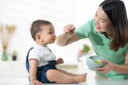 Parent feeding a baby